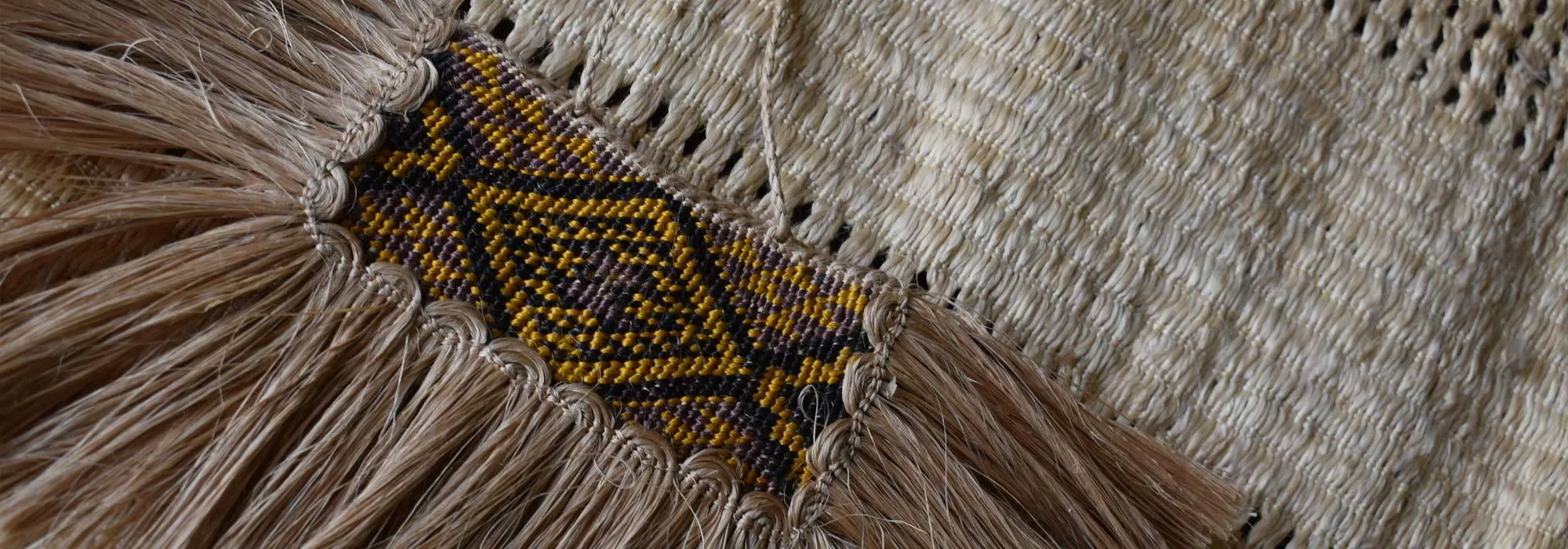 Carved taiaha and feathers